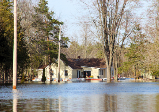 House in rural area surrounded by flood water