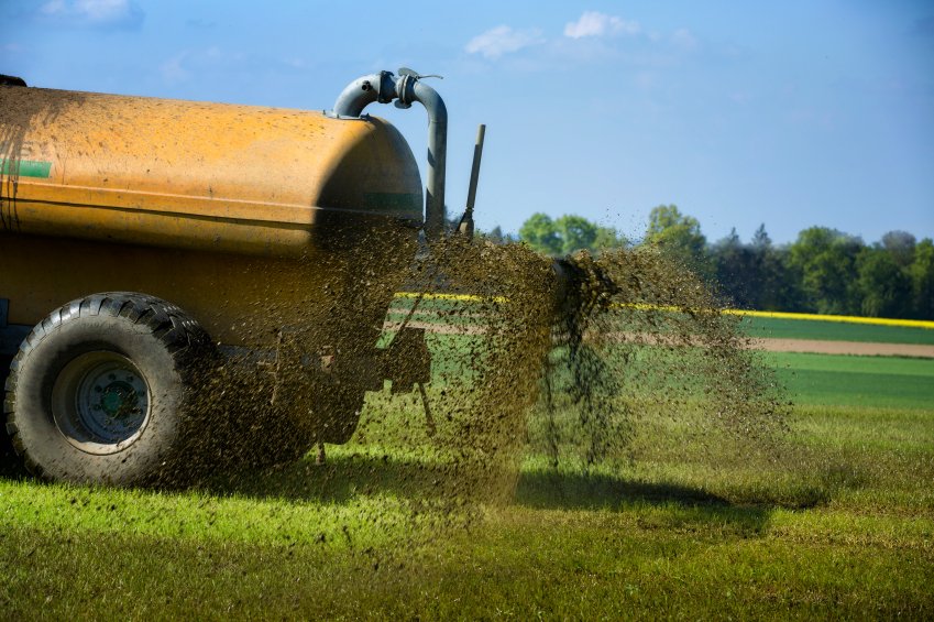 Farm equipment spreading fertilizer