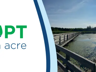 Promotional banner for "Adopt an Acre" featuring a scenic view of a sunlit wetland with a wooden walkway extending into the distance.