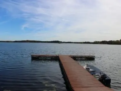a dock extends into a clear blue lake